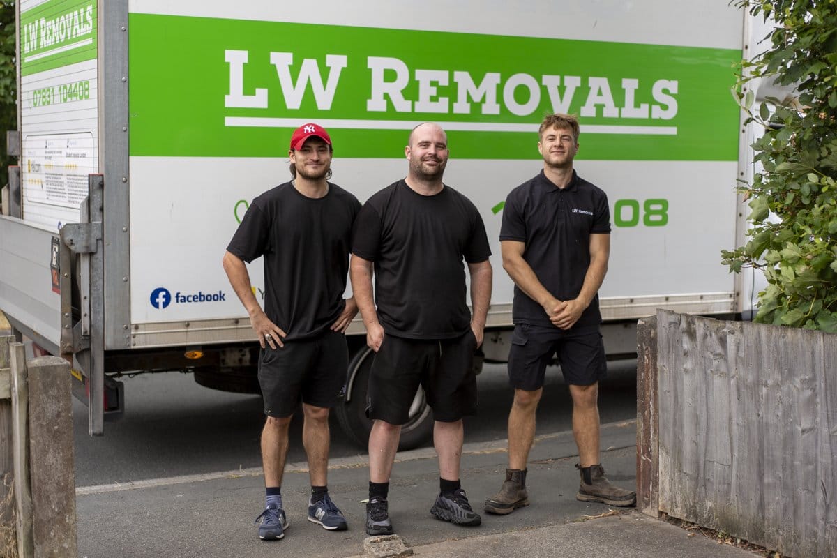 The LW Removals team standing in front of a branded removal van